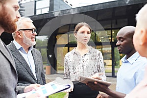 Group of Business People Discussing Work Outdoors