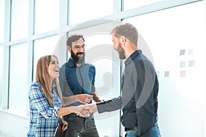 Group of business people with documents standing in the office corridor.