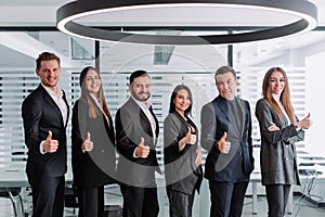 A group of business people a group holding a point with a finger up gesture at you