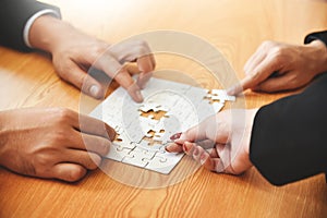 Group of Business people hands are holding jigsaw puzzle.