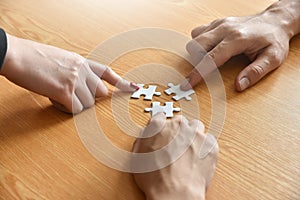 Group of Business people hands are holding jigsaw puzzle.