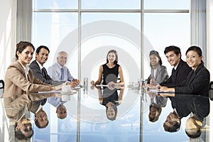 Group Of Business People Having Board Meeting Around Glass Table