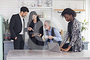 Group of business people having a discussion in an office pantry