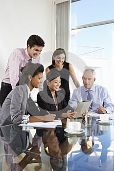 Group Of Business People Having Meeting Around Tablet Computer A