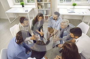 Group of business people having serious discussion during work meeting in office