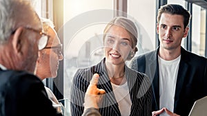 Group of business people having a work discussion indoors.