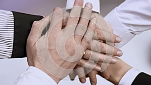 Group of business people holding hands together, symbol of teamwork and support