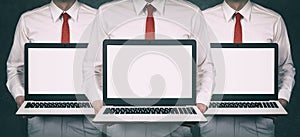 Group of business people holding laptops with blank screens