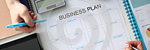 Group of business people holding working meeting at the table with paper documents, discussing annual business plan