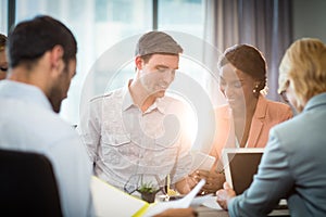 Group of business people interacting at desk