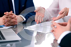 Group of business people and lawyers discussing contract papers photo