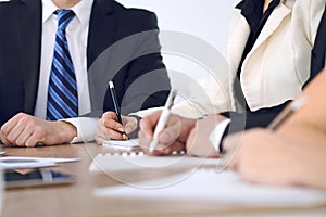 Group of business people or lawyers at meeting, hands close-up