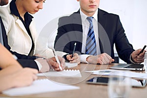 Group of business people or lawyers at meeting, hands close-up photo