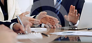 Group of business people or lawyers at meeting, hands close-up photo