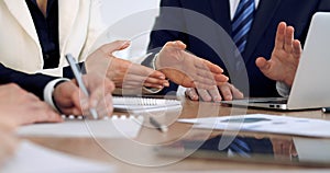 Group of business people or lawyers at meeting, hands close-up photo