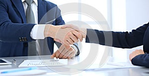 Group of business people or lawyers shaking hands finishing up a meeting , close-up. Success at negotiation and