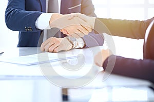 Group of business people or lawyers shaking hands finishing up a meeting , close-up. Success at negotiation and