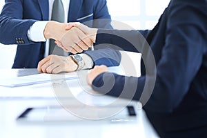 Group of business people or lawyers shaking hands finishing up a meeting , close-up. Success at negotiation and