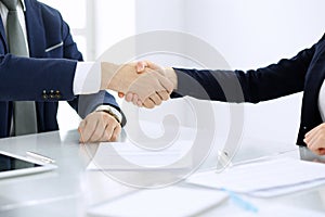 Group of business people or lawyers shaking hands finishing up a meeting , close-up. Success at negotiation and