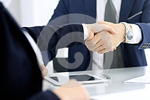 Group of business people or lawyers shaking hands finishing up a meeting , close-up. Success at negotiation and