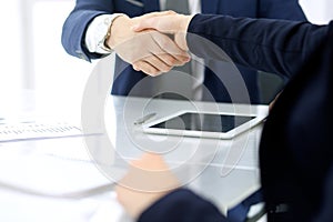 Group of business people or lawyers shaking hands finishing up a meeting , close-up. Success at negotiation and