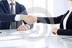 Group of business people or lawyers shaking hands finishing up a meeting , close-up. Success at negotiation and