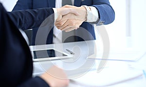 Group of business people or lawyers shaking hands finishing up a meeting , close-up. Success at negotiation and