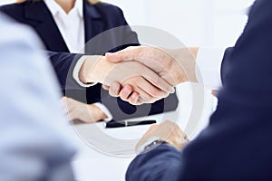 Group of business people or lawyers shaking hands finishing up a meeting , close-up. Success at negotiation and