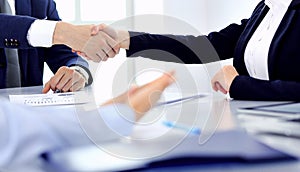 Group of business people or lawyers shaking hands finishing up a meeting , close-up. Success at negotiation and