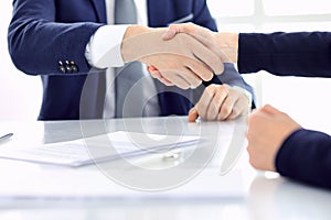 Group of business people or lawyers shaking hands finishing up a meeting , close-up. Success at negotiation and