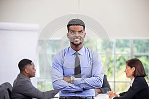 Group Of Business People Listening To Colleague Addressing Office Meeting