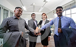 Group Of Business People Listening To Colleague Addressing Office Meeting