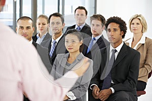 Group Of Business People Listening To Speaker Giving Presentation