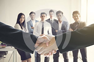 Group of business people making handshake agreement.