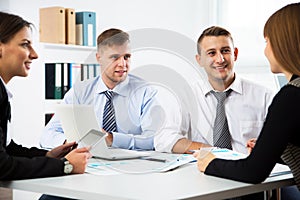 Group of business people at a meeting around a table