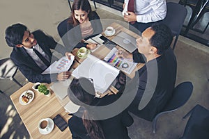 Group of business people meeting in conference room brainstorming consult business document graph chart office desk. Diversity