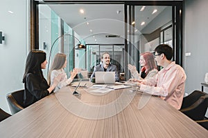 Group of business people meeting in a meeting room, sharing their ideas, Multi ethnic