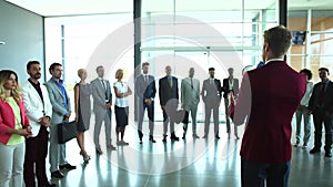 Group of business people of mixed ages are listening to a presentation at a business seminar and clapping.