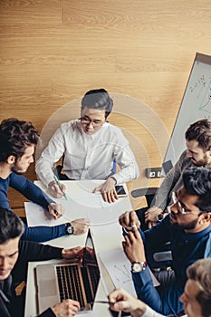 Group of business people in the modern conference room discuss work results.