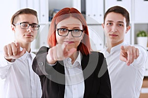 A group of business people pointing their