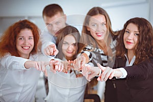 Group of business people pointing to you