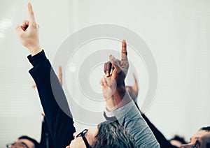 Group of business people pointing up at a copy of the space