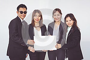 Group of business people posing with white board