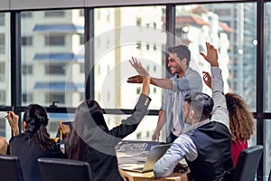 Group of business people raising hand and asking questions and discussing to business plan in the office photo