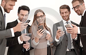 Group of business people reading a message on phones