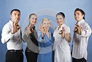 Group of business people showing okay sign photo