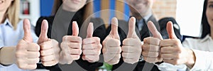 Group of business people showing thumb up in office closeup