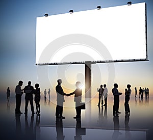 Group Of Business People Silhouettes Outdoors And An Empty Billboard Above