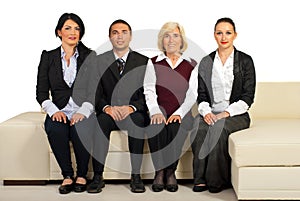 Group of business people sit on couch