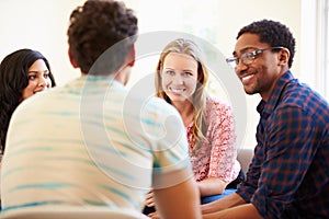 Group Of Business People Sitting On Chairs Having Meeting